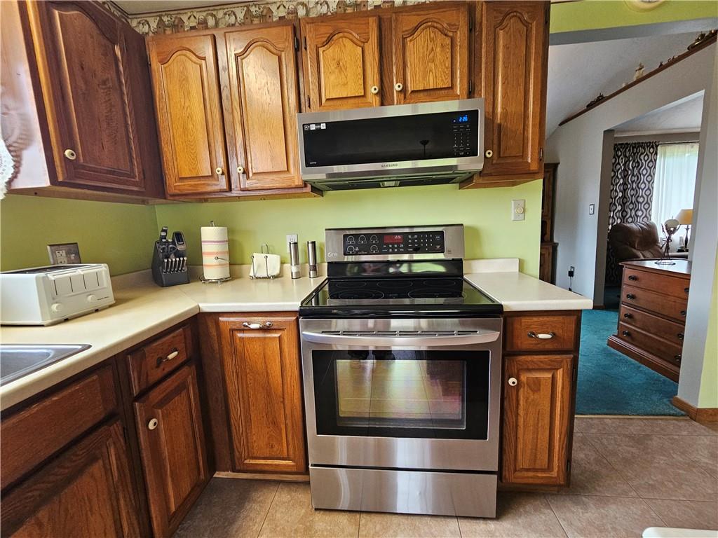 323 Hoon Road Butler, PA 16001 - Photo 34 of 49 a kitchen with stainless steel appliances granite countertop a stove and a microwave