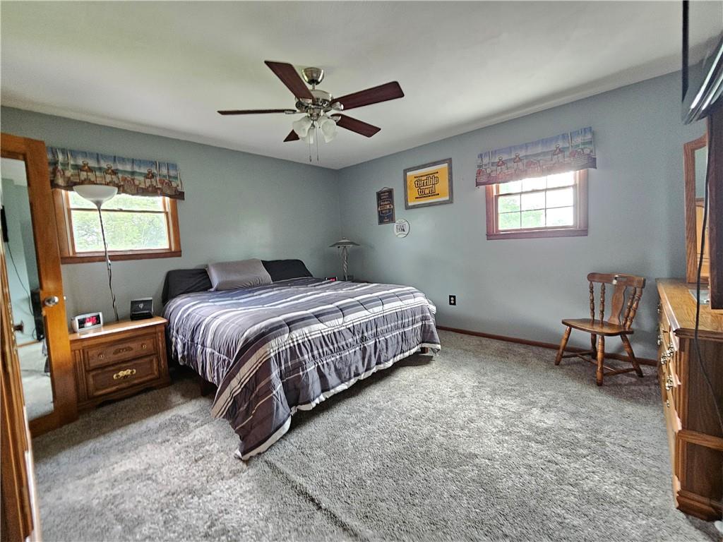 323 Hoon Road Butler, PA 16001 - Photo 39 of 49 a bedroom with a bed and a chandelier