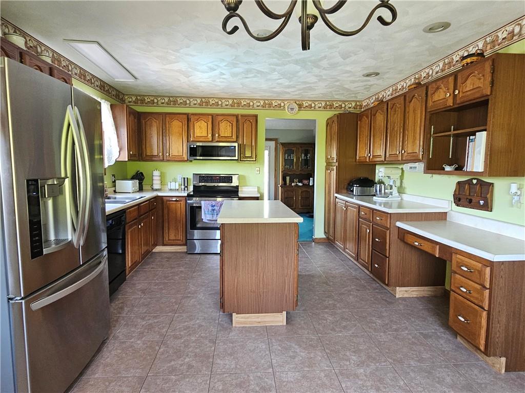 323 Hoon Road Butler, PA 16001 - Photo 5 of 49 a kitchen with stainless steel appliances granite countertop a refrigerator a sink and a stove