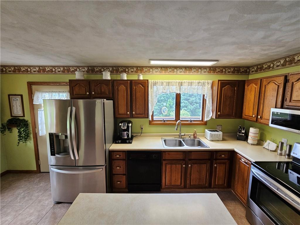 323 Hoon Road Butler, PA 16001 - Photo 7 of 49 a kitchen with stainless steel appliances granite countertop a refrigerator and a sink