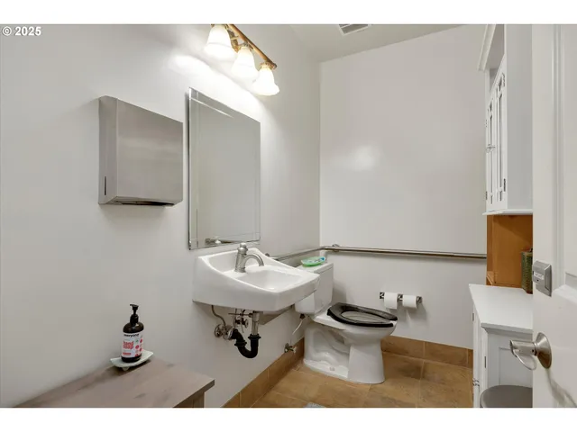 a kitchen with a stove a sink and a window