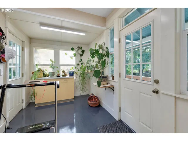 a bed room with a bed mirror and a window
