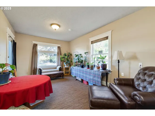 a living room with furniture and a book shelf