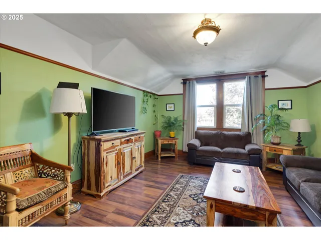 a bedroom with a bed window and a chandelier
