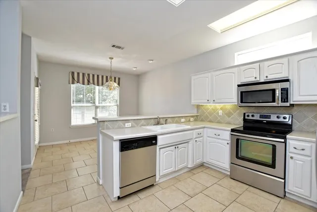 a kitchen with a stove sink and microwave