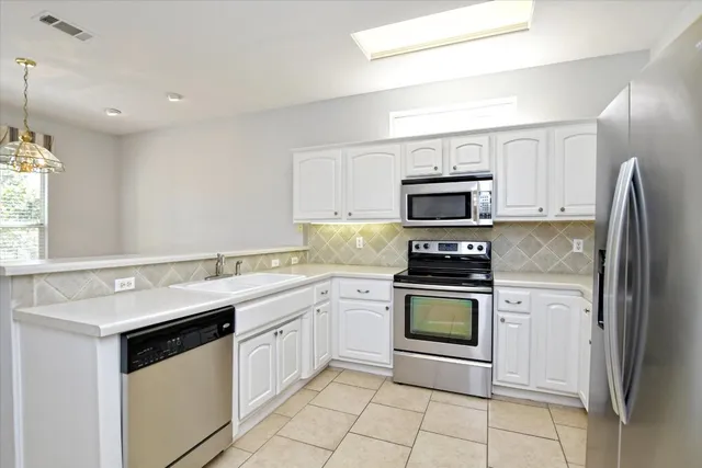 a kitchen with a sink stove and microwave