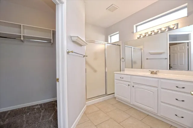 a spacious bathroom with a shower and a sink