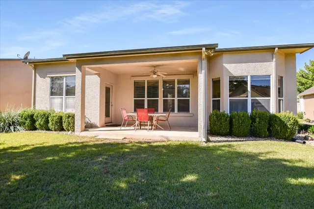 a view of a house with backyard and porch