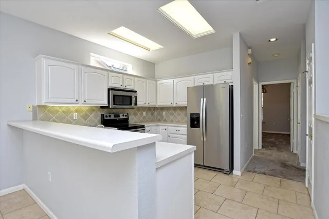 a kitchen with a refrigerator a microwave and sink