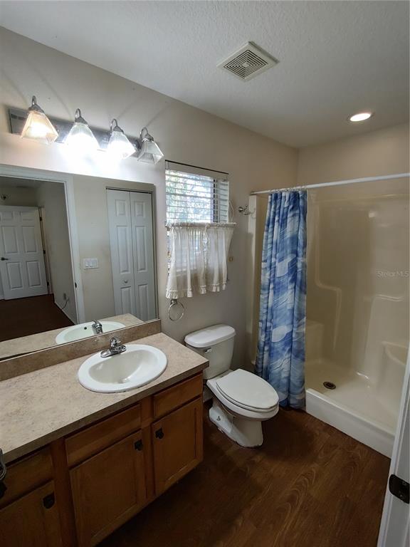 7688 Southwest 77 Place Ocala, FL 34476 - Photo 13 of 16 a bathroom with a sink toilet a mirror and shower