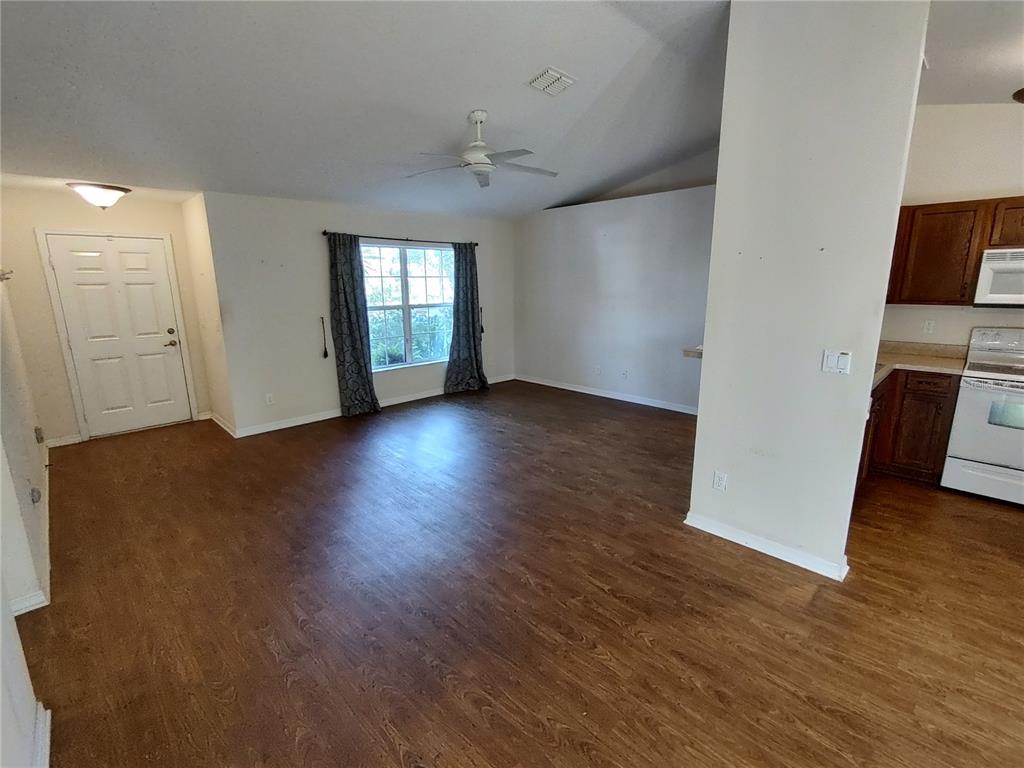 7688 Southwest 77 Place Ocala, FL 34476 - Photo 3 of 16 an empty room with wooden floor and windows