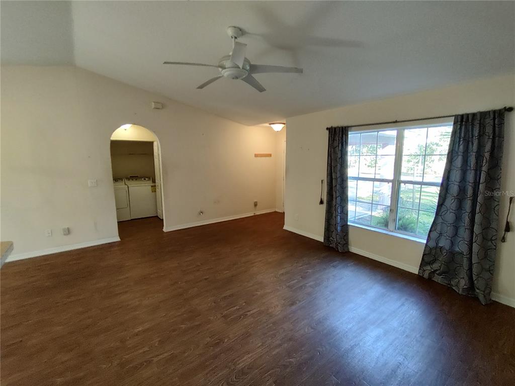 7688 Southwest 77 Place Ocala, FL 34476 - Photo 4 of 16 an empty room with wooden floor and windows