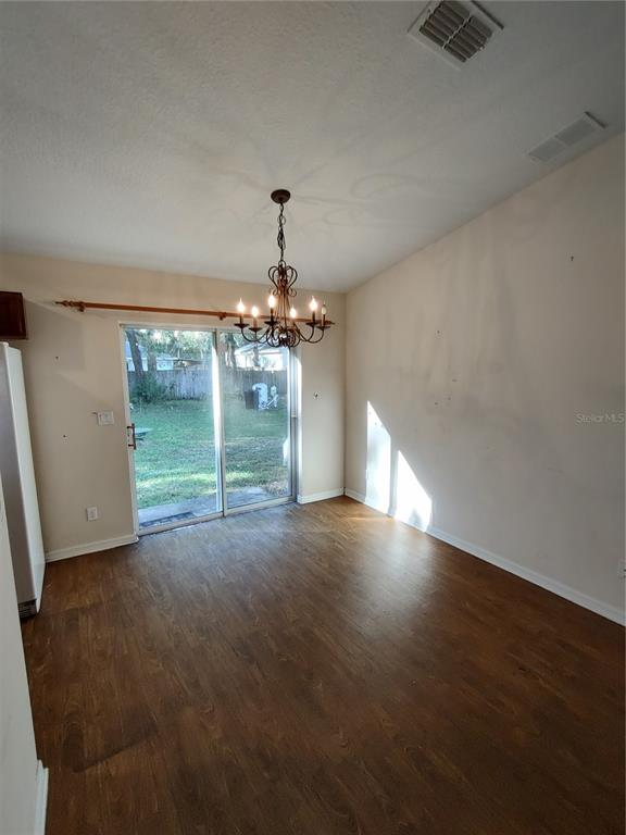 7688 Southwest 77 Place Ocala, FL 34476 - Photo 5 of 16 a view of a livingroom with a chandelier fireplace and window