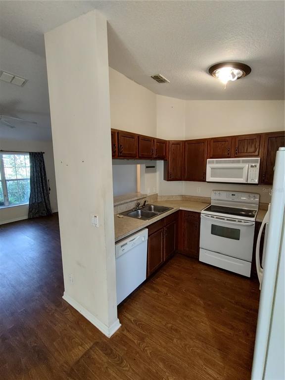 7688 Southwest 77 Place Ocala, FL 34476 - Photo 6 of 16 a kitchen with granite countertop a stove and a refrigerator