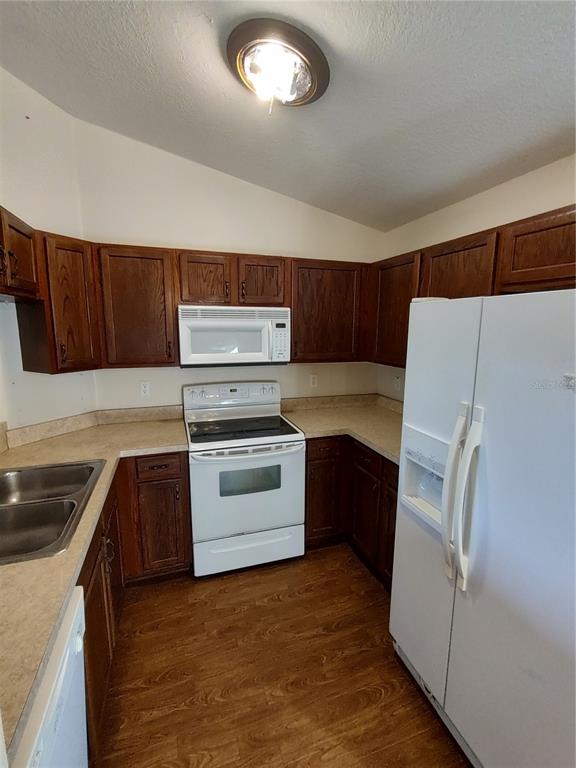 7688 Southwest 77 Place Ocala, FL 34476 - Photo 7 of 16 a kitchen with a refrigerator sink and stove