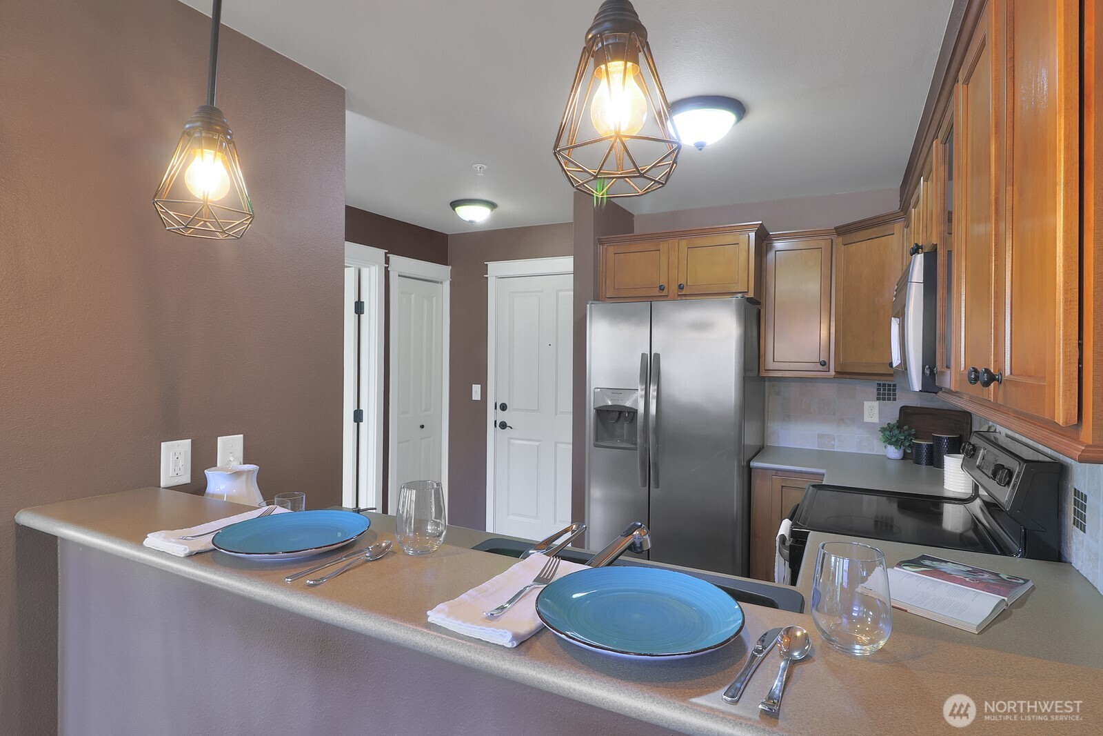 690 32nd Street, Unit B211 Bellingham, WA 98225 - Photo 5 of 23 a kitchen with stainless steel appliances granite countertop a sink refrigerator and cabinets