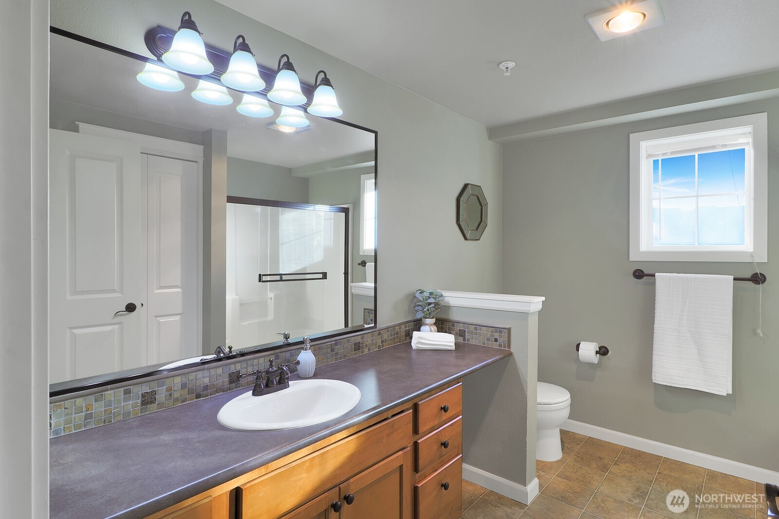 690 32nd Street, Unit B211 Bellingham, WA 98225 - Photo 6 of 23 a bathroom with a granite countertop sink and a mirror