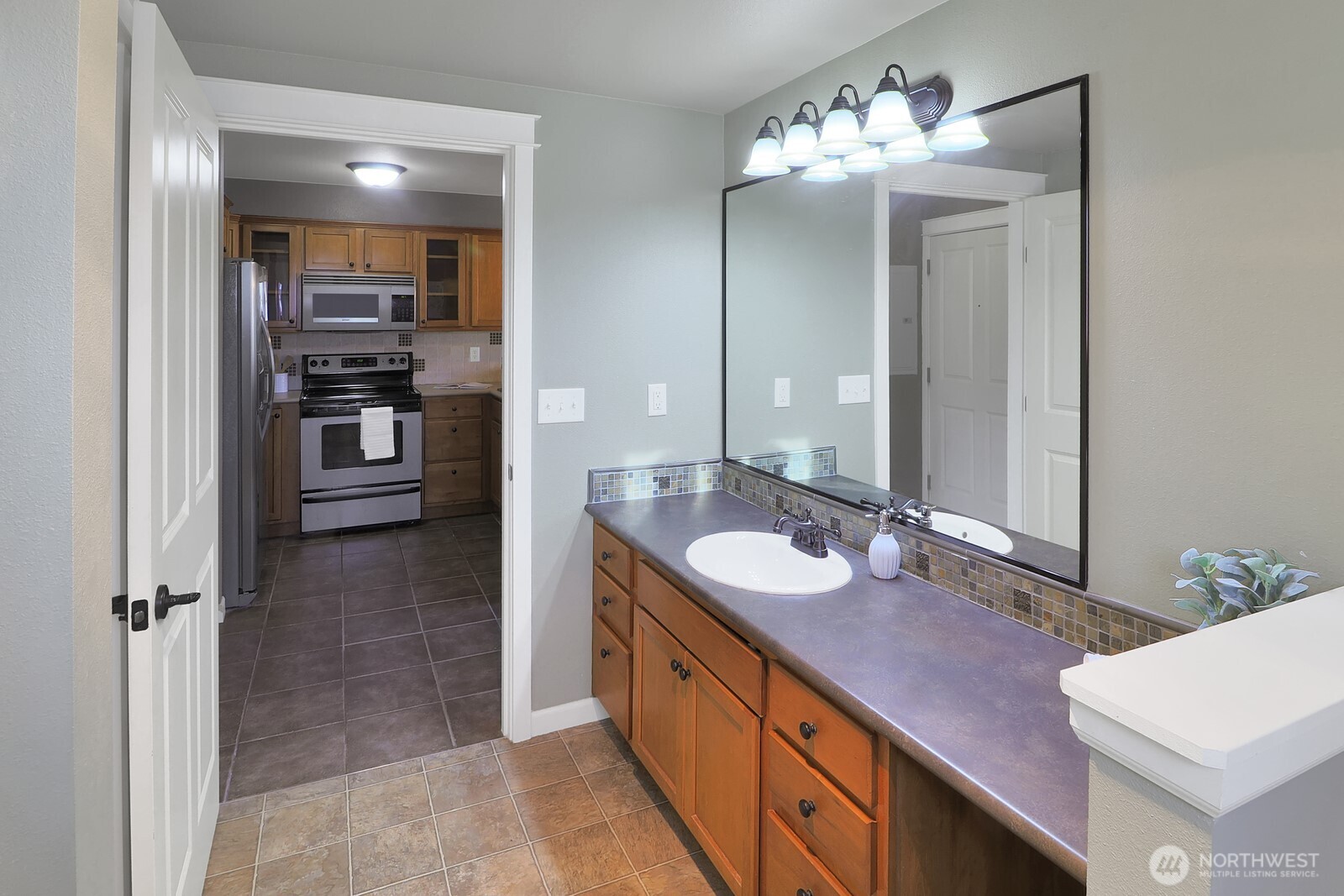 690 32nd Street, Unit B211 Bellingham, WA 98225 - Photo 8 of 23 a bathroom with a sink and a mirror