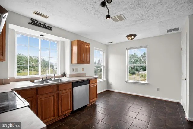 a large kitchen with a large window