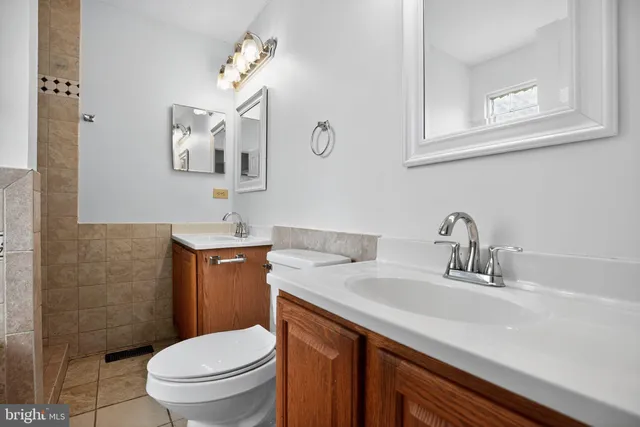a bathroom with a sink a toilet and mirror