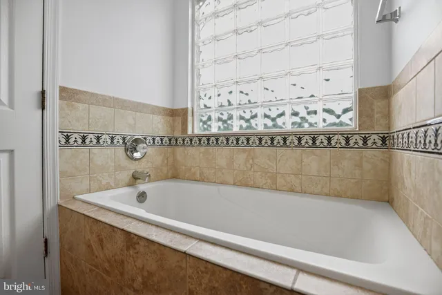 a bathroom with a bathtub and shower