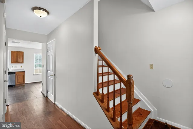 a view of an entryway with wooden floor and a livingroom