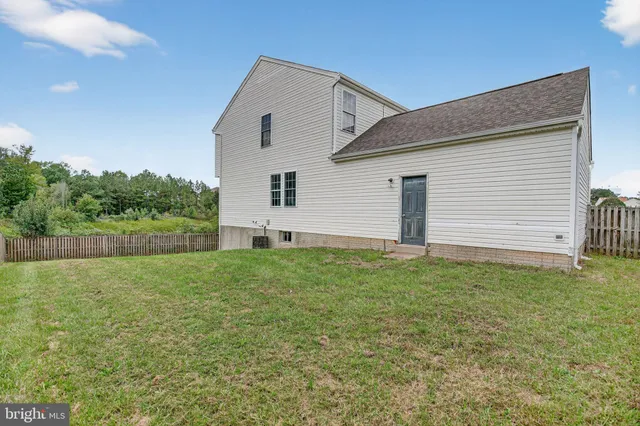 a view of a backyard with plants and a backyard