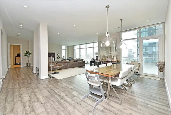 a kitchen with a sink a refrigerator and white cabinets