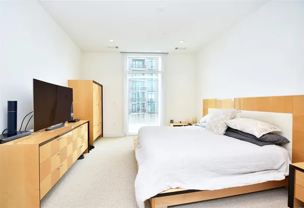 a bed room with a bed and a night stand