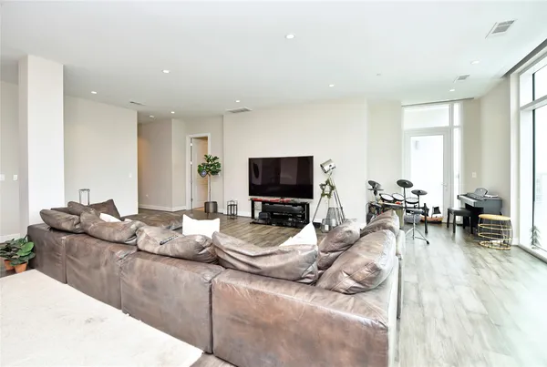 a living room with furniture and a wooden floor