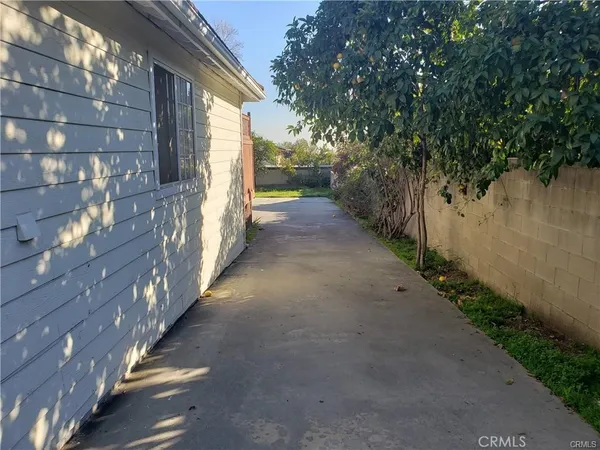 a view of a pathway of a house with a yard