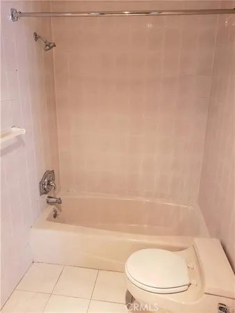 a bathroom with a bathtub and a toilet