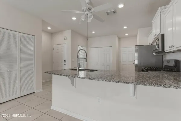 an empty room with windows and cabinet