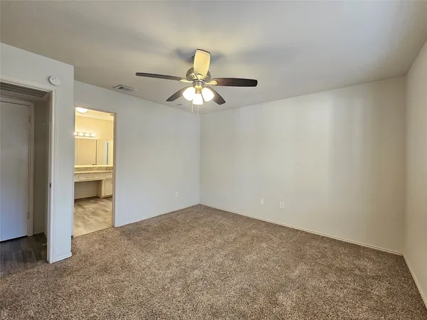 an empty room with a empty space and a ceiling fan