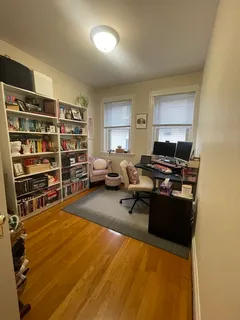 a livingroom with furniture and a book shelf