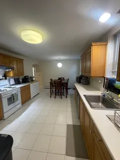 a kitchen with a sink cabinets and window