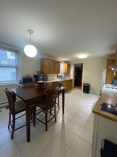 a kitchen with a dining table and chairs