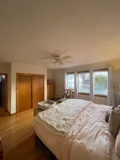 a bedroom with a large bed and a chandelier