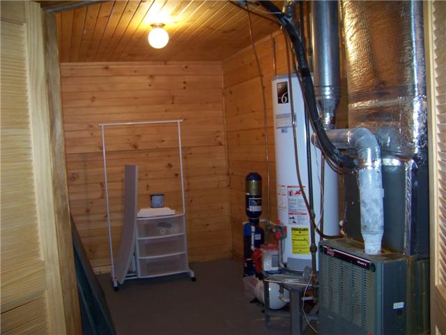 171 Love Lady Hollow Road Tennessee Ridge, TN 37178 - Photo 14 of 20 THE MECHANICAL ROOM IN THE BASEMENT HOUSES, THE GAS FURNACE AND WATER HEATER.