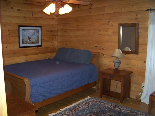 171 Love Lady Hollow Road Tennessee Ridge, TN 37178 - Photo 7 of 20 A 14X14 MAIN FLOOR BEDROOM HAS A BEAMED TONGUE-IN-GROOVE CEILING AND LARGE CLOSET.