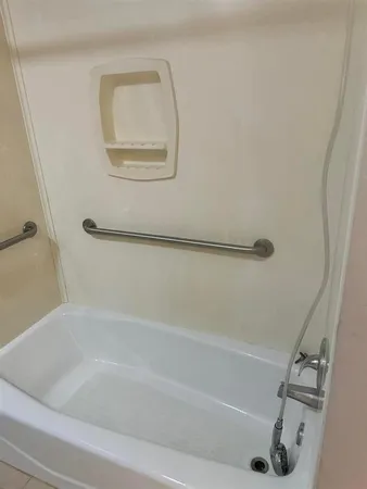 a bathroom with a bath tub and a shower