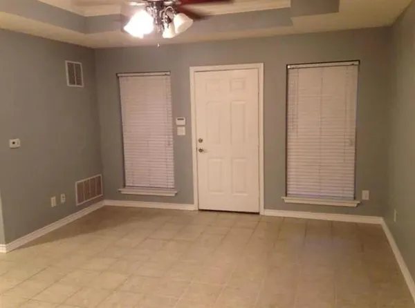 an empty room with windows and closet