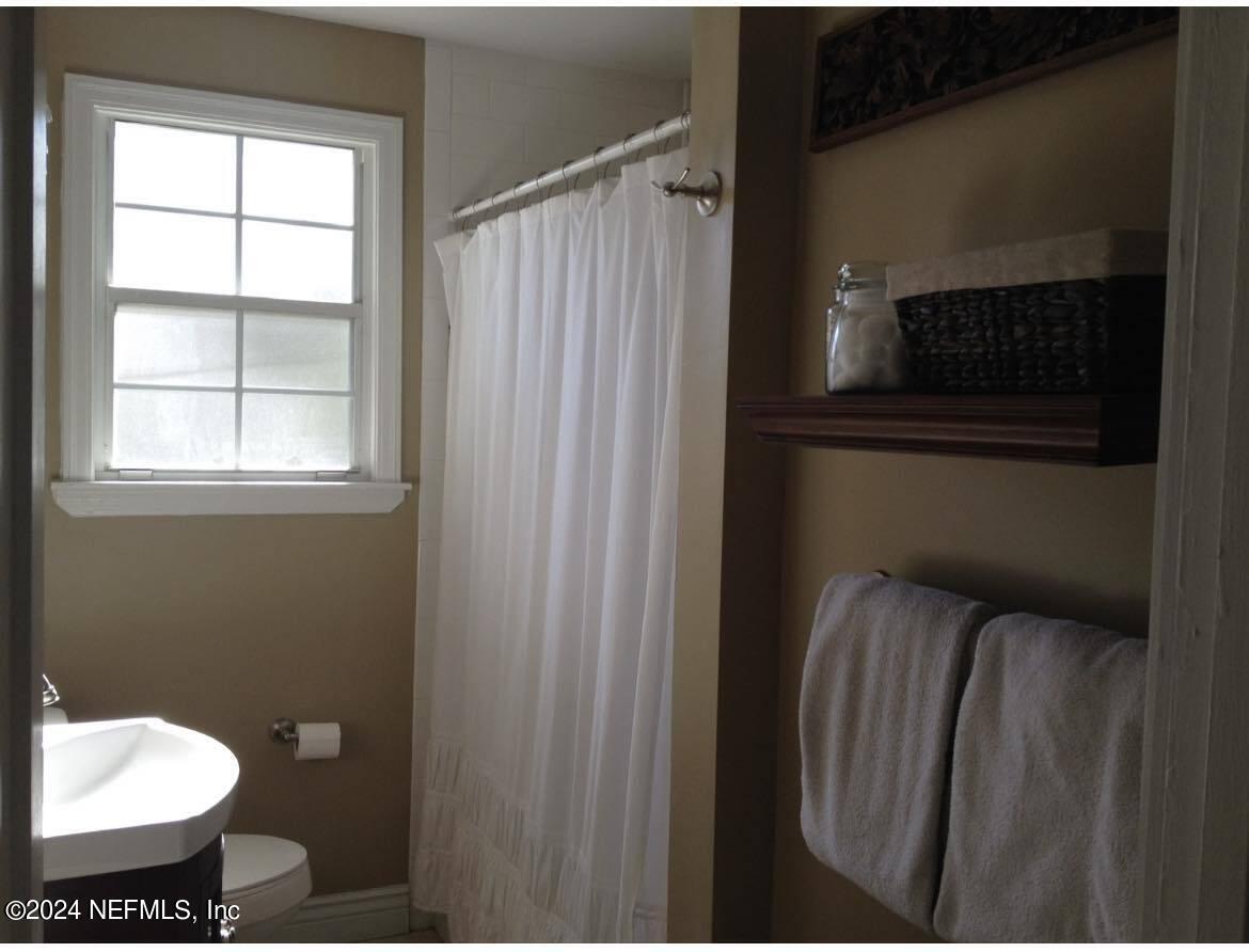 1724 Planters Road Jacksonville, FL 32207 - Photo 8 of 17 a bathroom with a toilet and a mirror