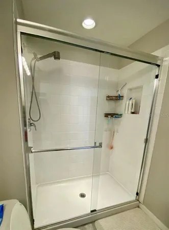 a bathroom with a glass shower door