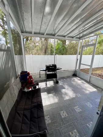 a living room with furniture and a floor to ceiling window