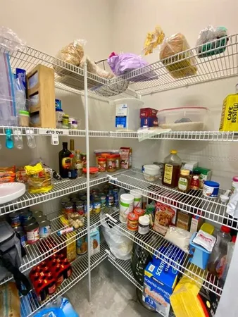a store room with stainless steel appliances and couch