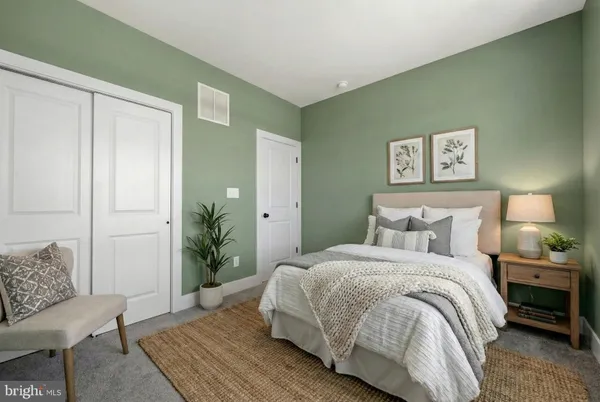 a bedroom with a bed and a couch