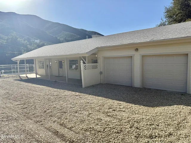 a view of a backyard of the house