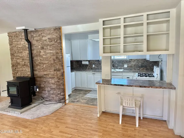 a kitchen with a cabinets and chairs