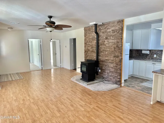 a view of an empty room with a fireplace
